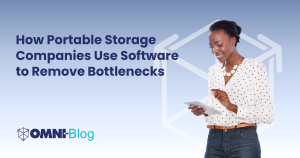 How Portable Storage Companies Use Software to Remove Bottlenecks Omni Blog Blue background Omni~View logo behind woman on iPad