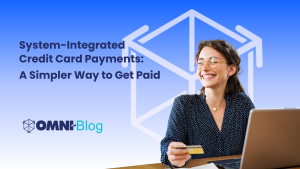 System-Integrated Credit Card Payments: A simpler way to get paid - woman smiling at computer holding credit card